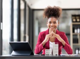 Asian businesswoman making a deal to buy a house or condo inside the office, home insurance concept