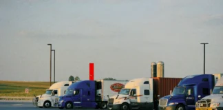 Commercial trucking fleet parked at a transportation facility